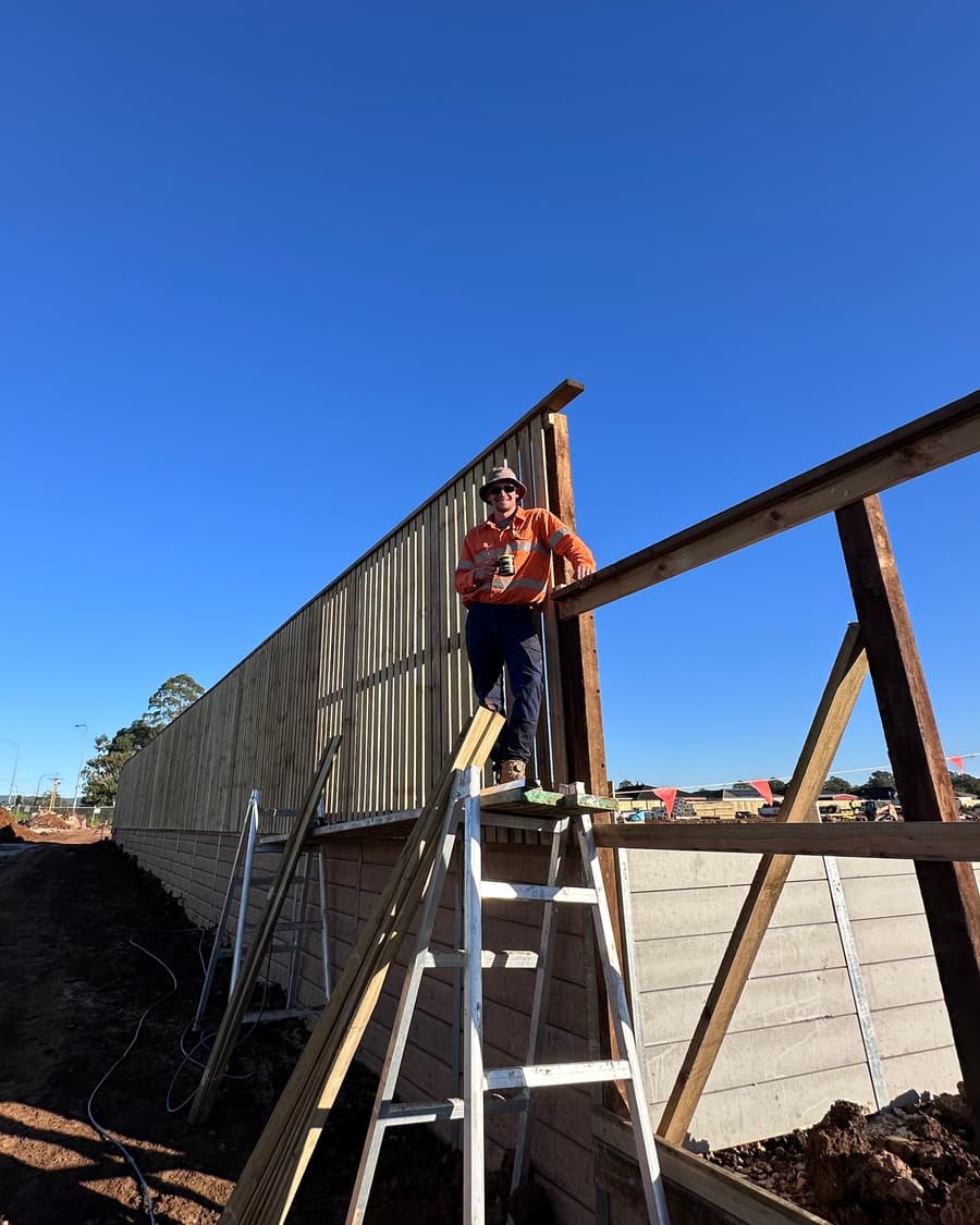 Tom, owner of Tough Reliable Fencing, on site building a timber fence in South East Queensland