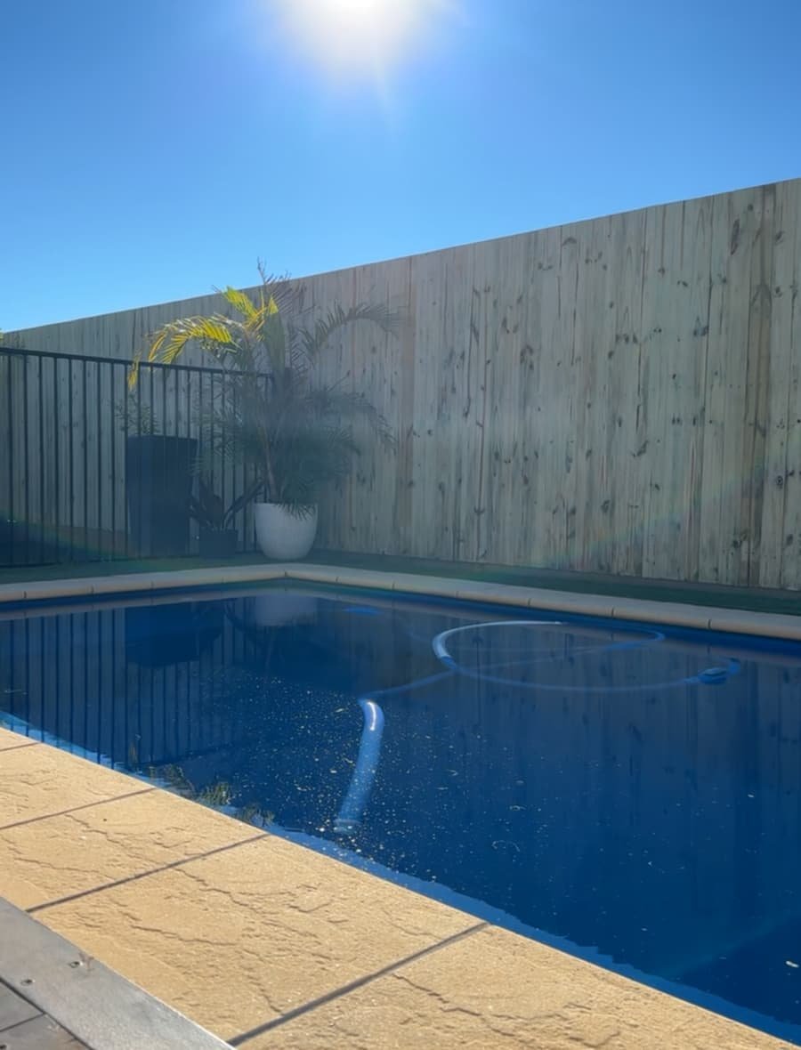 Timber pool privacy fence with paved surround built by Tough Reliable Fencing in Brisbane